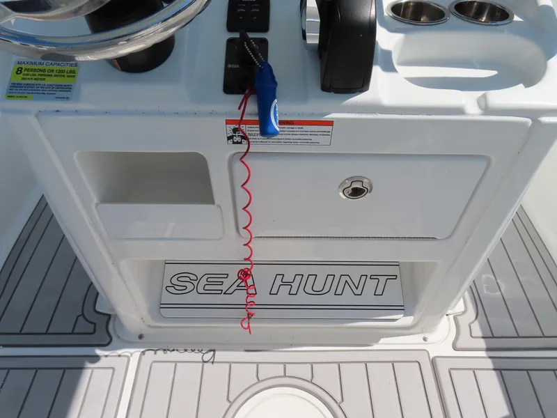 Slide: The Image of 2019 Sea Hunt Ultra 234 boat console with steering wheel and controls. - 24