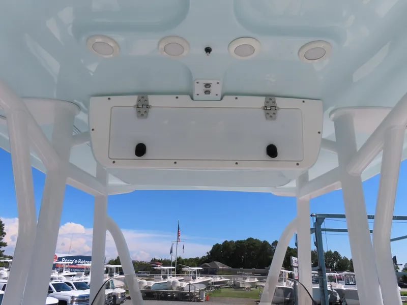 Slide: The Image of 2019 Sea Hunt Ultra 234 boat T-top with storage compartment and speakers. - 25