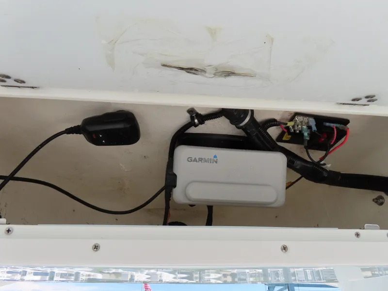Slide: The Image of Electrical wiring and Garmin device inside a 2019 Sea Hunt Ultra 234 boat compartment. - 26