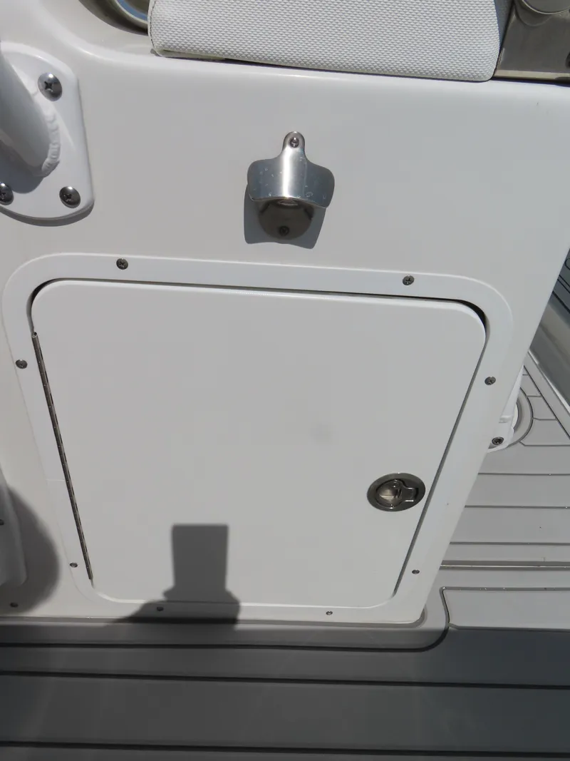 Slide: The Image of 2019 Sea Hunt Ultra 234 boat storage compartment with latch and handle. - 30