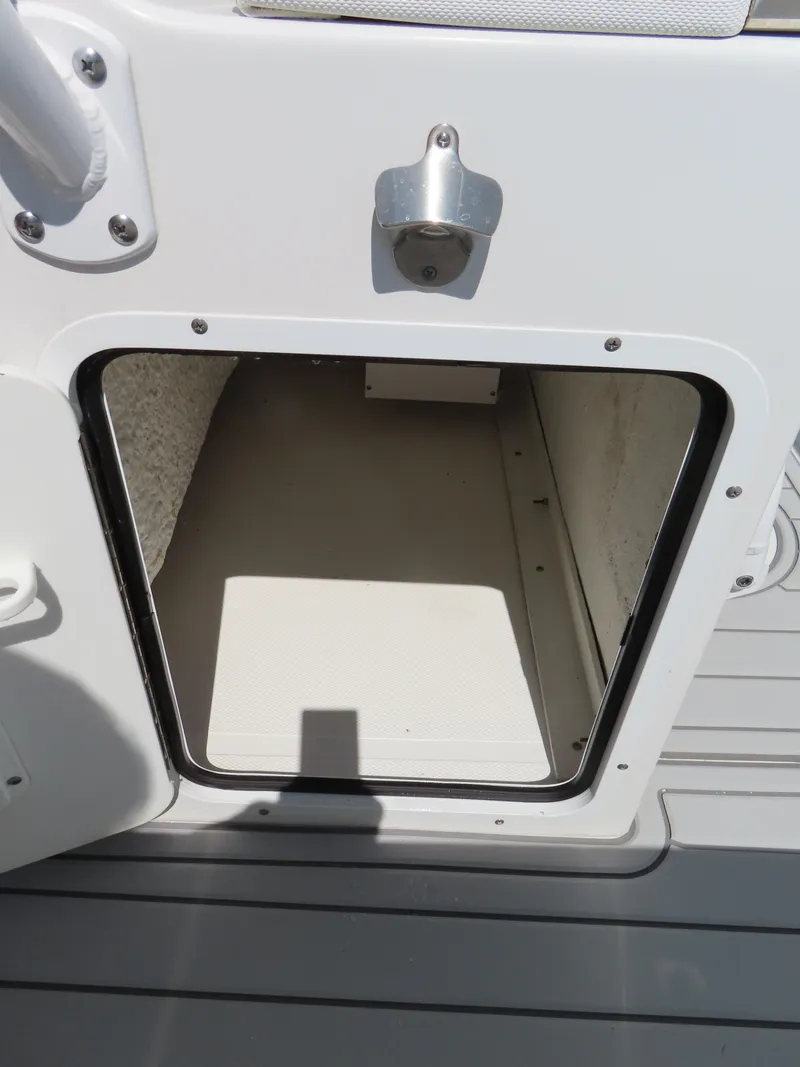 Slide: The Image of Open storage compartment on a 2019 Sea Hunt Ultra 234 boat. - 31