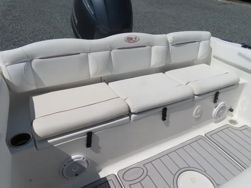 Slide: The Image of 2019 Sea Hunt Ultra 234 boat interior with cushioned seating and storage compartments. - 34