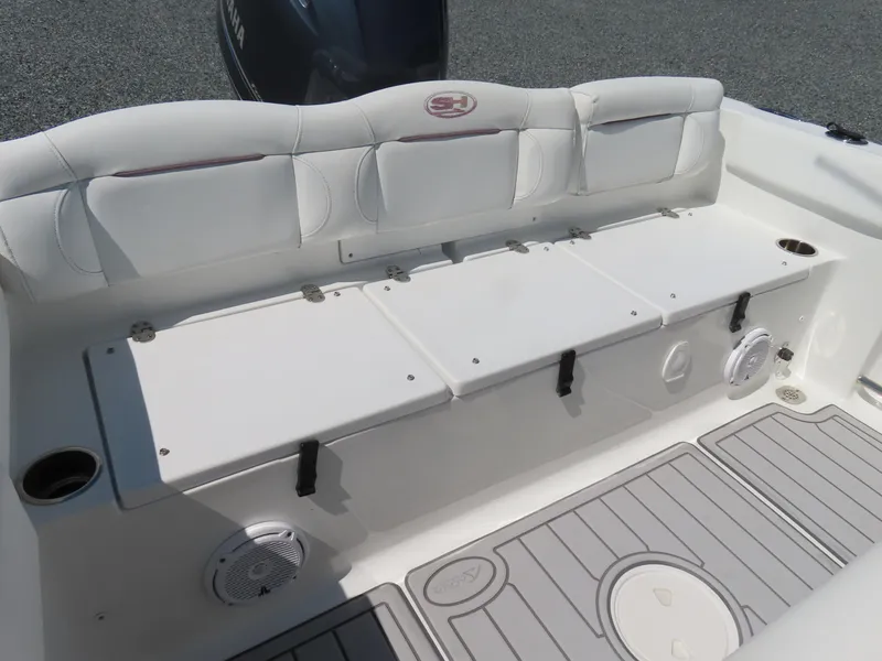 Slide: The Image of 2019 Sea Hunt Ultra 234 boat interior with cushioned seating and storage compartments. - 35