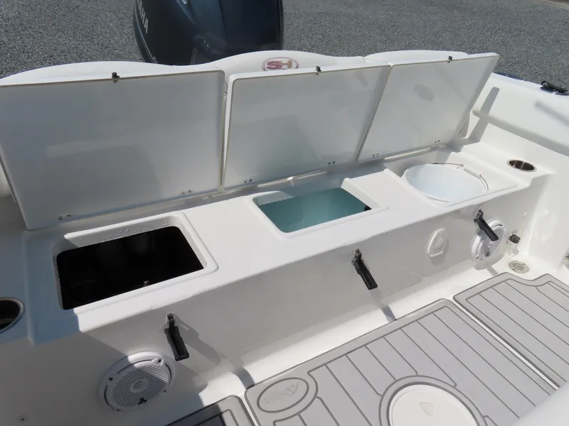 Slide: The Image of 2019 Sea Hunt Ultra 234 boat with open storage compartments and Yamaha engine. - 36
