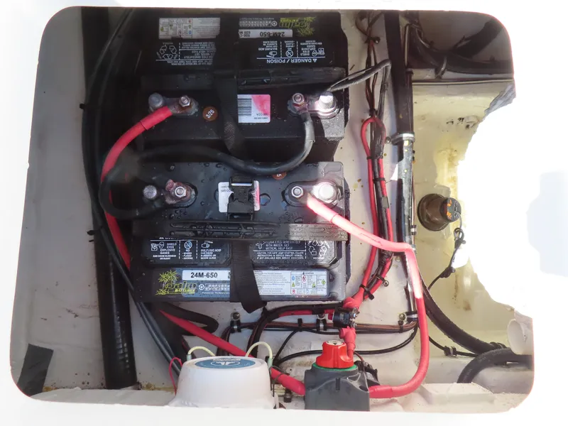 Slide: The Image of 2019 Sea Hunt Ultra 234 boat battery compartment with wiring and connections. - 37
