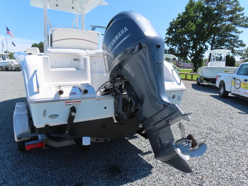 Slide: The Image of 2019 Sea Hunt Ultra 234 boat with Yamaha outboard motor, parked on gravel. - 4