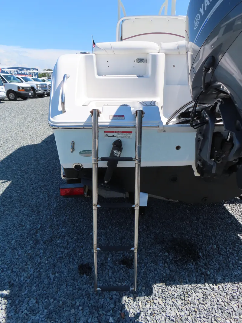 Slide: The Image of 2019 Sea Hunt Ultra 234 boat with ladder and Yamaha motor on gravel. - 6