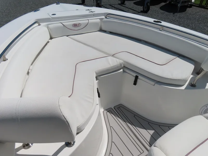 Slide: The Image of 2019 Sea Hunt Ultra 234 boat interior with white cushioned seating. - 7