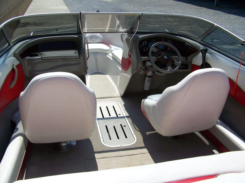 Slide: The Image of Interior of a 2001 Crownline 180 BR boat, featuring steering wheel and seating. - 4