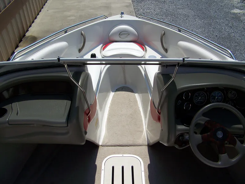 Slide: The Image of Interior view of a 2001 Crownline 180 BR boat, featuring steering wheel and seating area. - 5