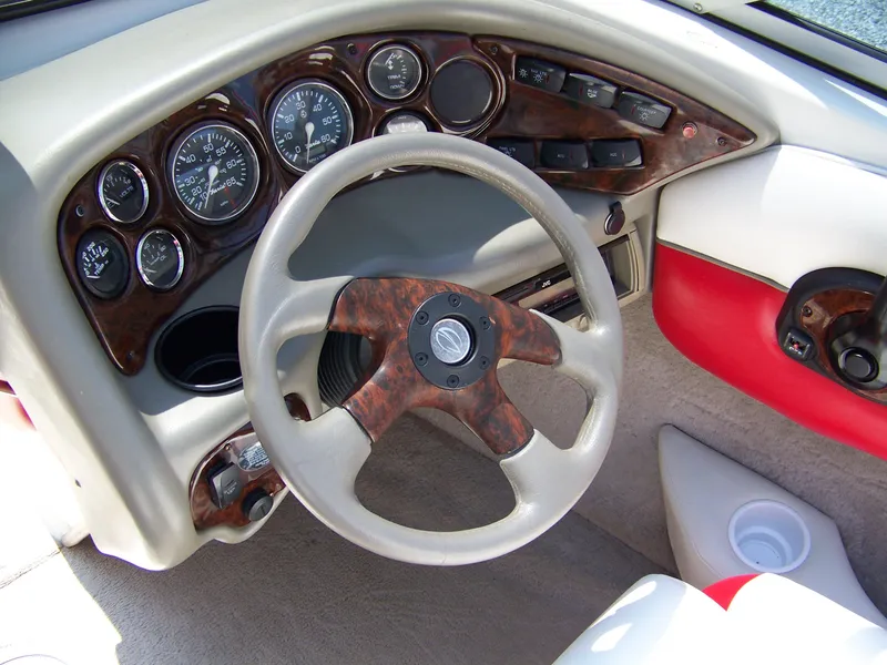Slide: The Image of 2001 Crownline 180 BR boat dashboard with wood accents and steering wheel. - 6