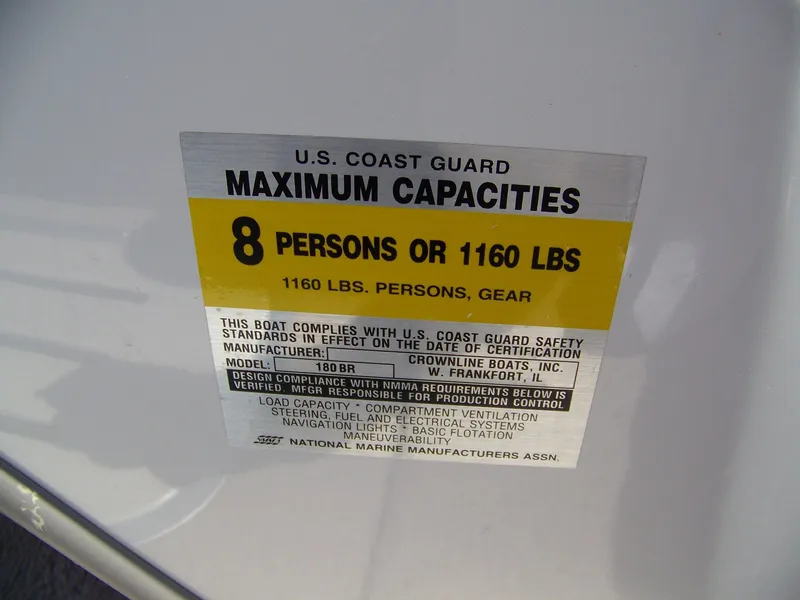 Slide: The Image of 2001 Crownline 180 BR boat capacity label, max 8 persons or 1160 lbs, U.S. Coast Guard compliant. - 9