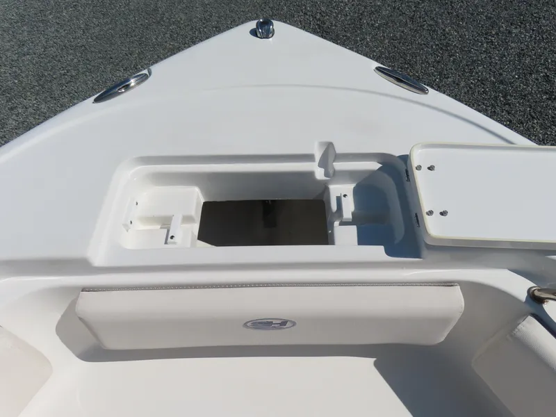 Slide: The Image of 2023 Sea Hunt Ultra 229 boat deck with storage compartment and seating. - 12