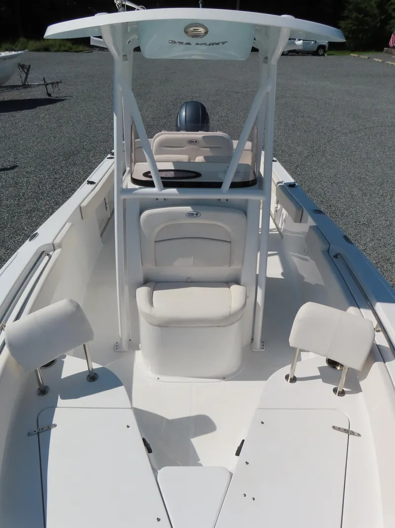 Slide: The Image of 2023 Sea Hunt Ultra 229 boat interior with seating and console, viewed from above. - 13