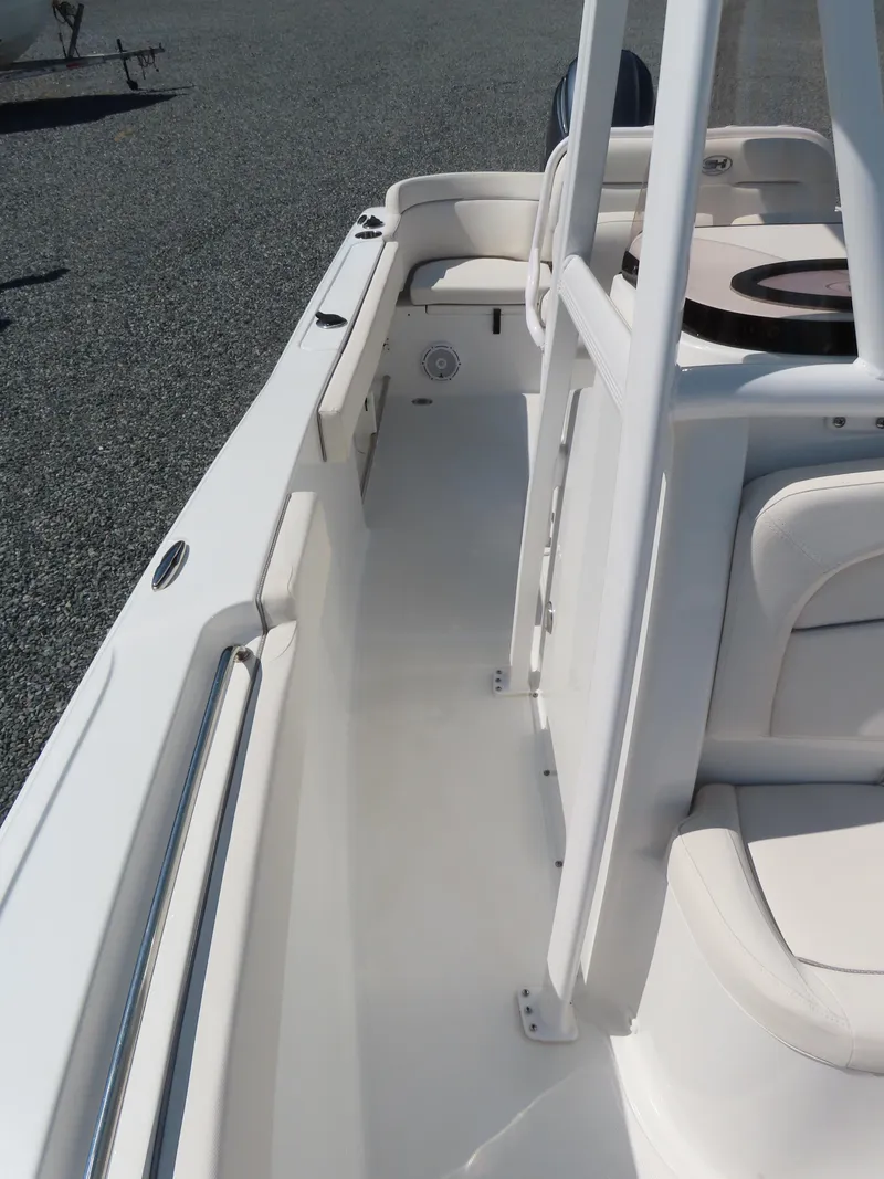 Slide: The Image of 2023 Sea Hunt Ultra 229 boat interior with white seating and sleek design. - 14