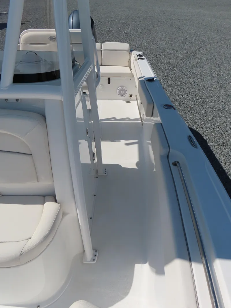 Slide: The Image of 2023 Sea Hunt Ultra 229 boat interior with white seating and spacious deck. - 15