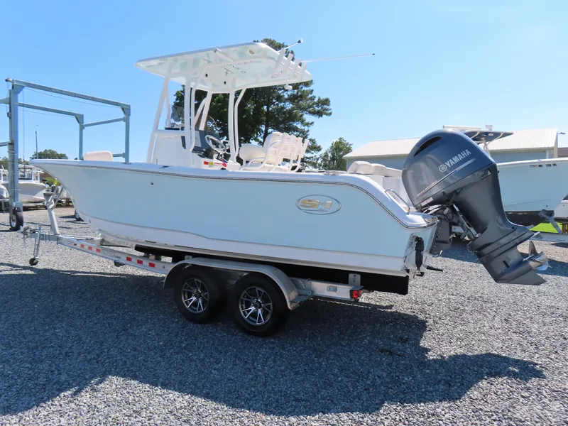 Slide: The Image of 2023 Sea Hunt Ultra 229 boat on trailer with Yamaha outboard motor. - 2