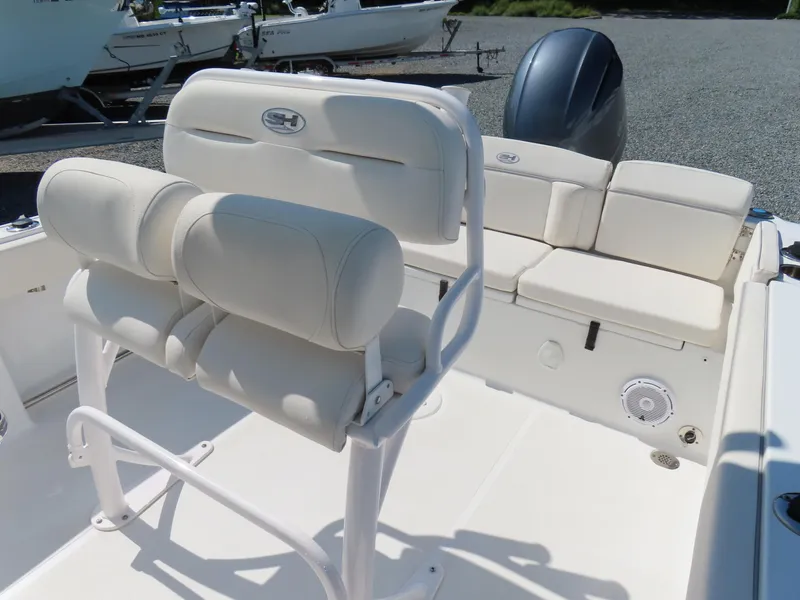 Slide: The Image of 2023 Sea Hunt Ultra 229 boat interior with white seating and console. - 20