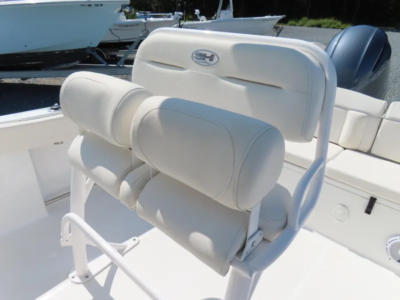 Slide: The Image of 2023 Sea Hunt Ultra 229 boat seating with white cushioned design. - 21