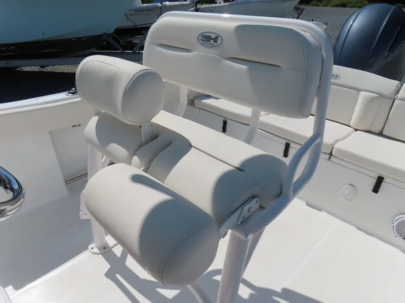 Slide: The Image of 2023 Sea Hunt Ultra 229 boat seat with white cushioned design. - 22