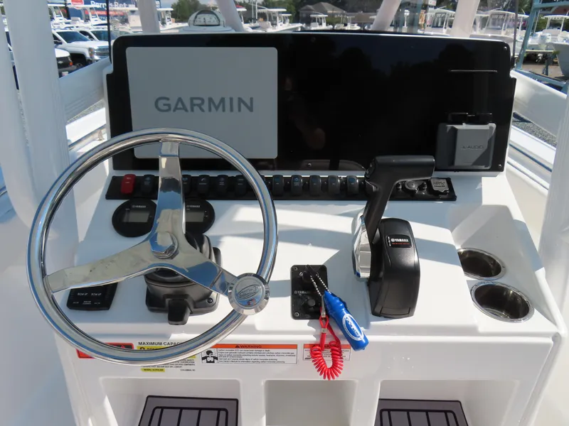 Slide: The Image of 2023 Sea Hunt Ultra 229 boat console with Garmin display and Yamaha controls. - 23