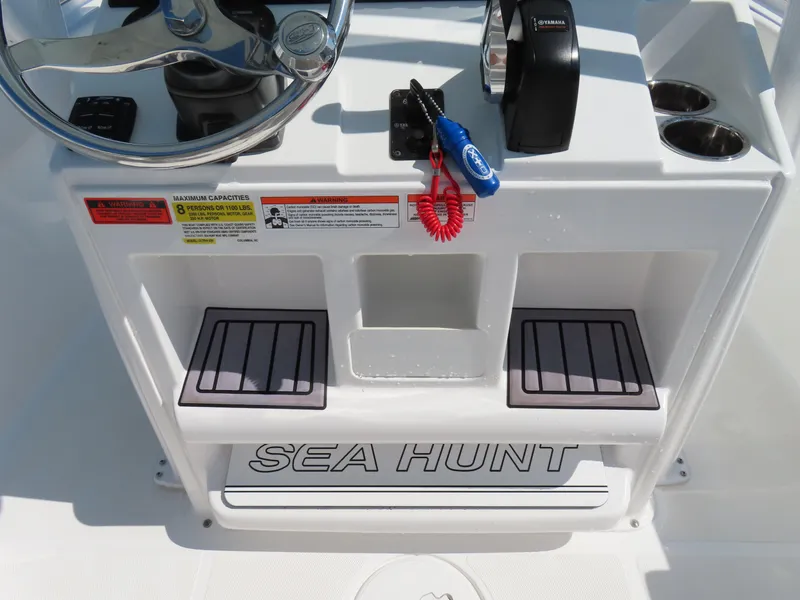 Slide: The Image of 2023 Sea Hunt Ultra 229 boat console with steering wheel and controls. - 24