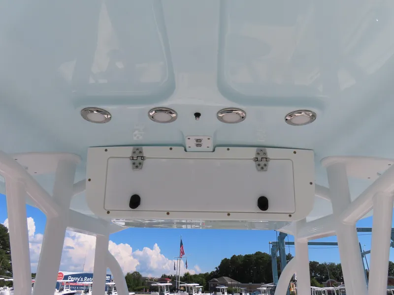 Slide: The Image of 2023 Sea Hunt Ultra 229 boat interior ceiling with storage compartment and lights. - 26