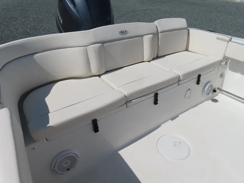 Slide: The Image of 2023 Sea Hunt Ultra 229 boat interior with cushioned seating and Yamaha engine. - 29