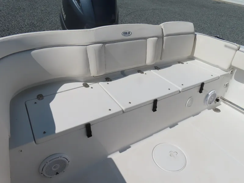 Slide: The Image of 2023 Sea Hunt Ultra 229 boat interior with cushioned seating and storage compartments. - 30