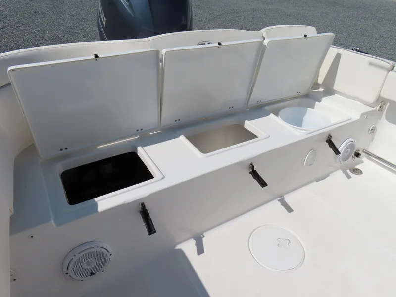 Slide: The Image of 2023 Sea Hunt Ultra 229 boat interior with storage compartments and speaker. - 31