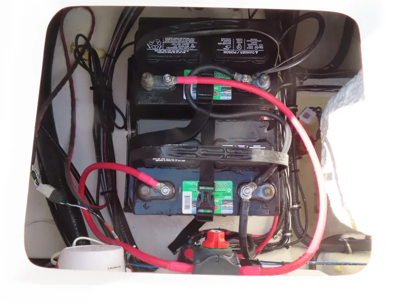 Slide: The Image of Battery compartment of 2023 Sea Hunt Ultra 229 boat with wiring and connections. - 32