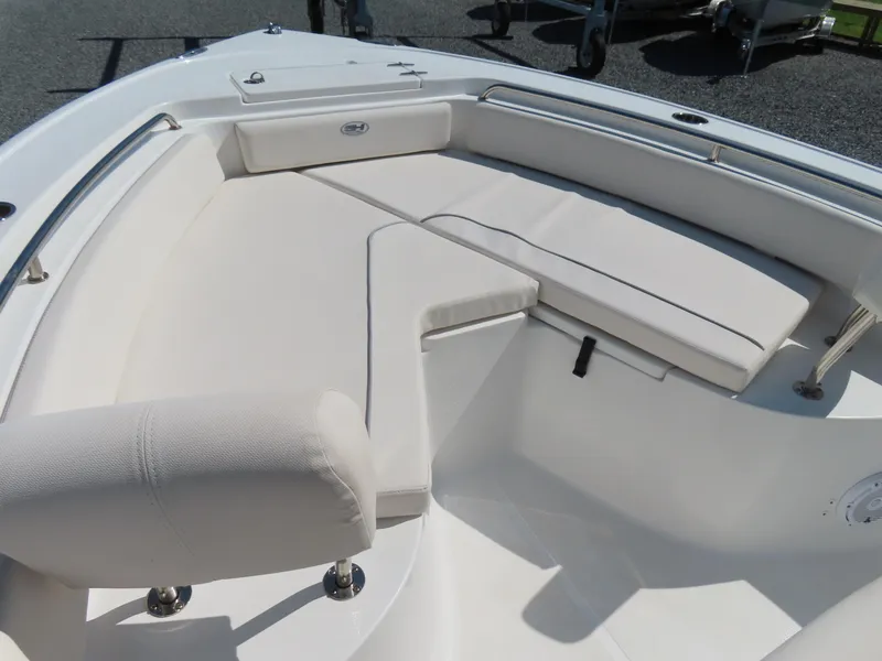 Slide: The Image of 2023 Sea Hunt Ultra 229 boat interior with cushioned seating and stainless steel railings. - 6
