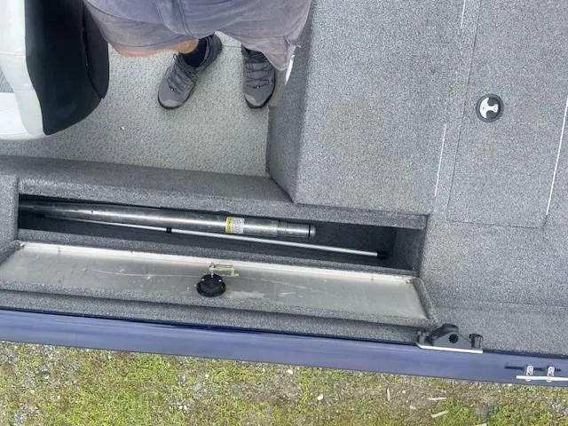 Slide: The Image of 2019 Tracker Pro Guide V-175 Combo boat interior with storage compartment open. - 10