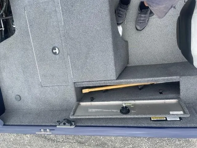 Slide: The Image of 2019 Tracker Pro Guide V-175 Combo boat interior with open storage compartment. - 11