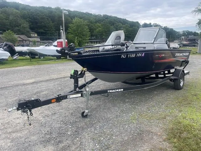 Slide: The Image of 2019 Tracker Pro Guide V-175 Combo boat on trailer, parked outdoors. - 4