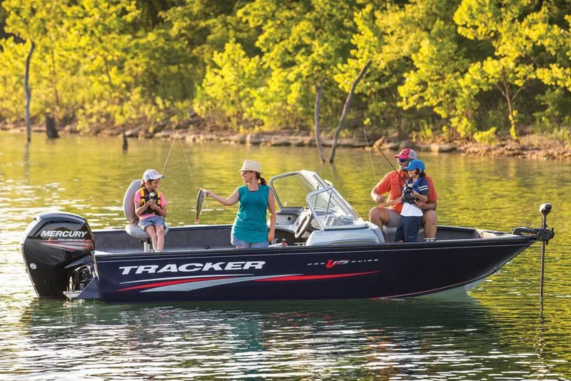 Slide: The Image of 2019 Tracker Pro Guide V-175 Combo boat on a serene lake with people fishing. - 40