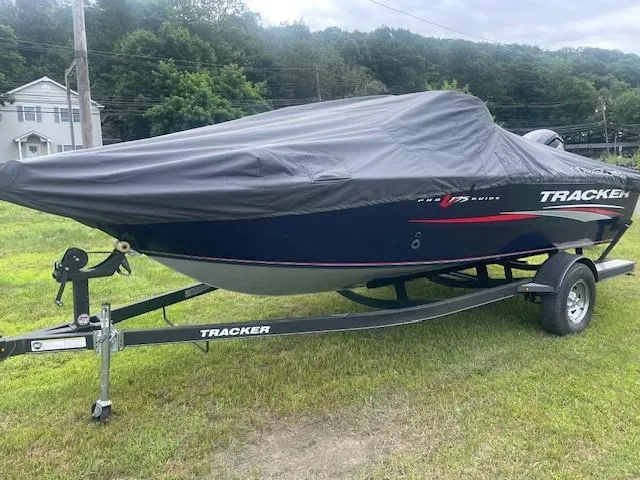 Slide: The Image of 2019 Tracker Pro Guide V-175 Combo boat covered on trailer, parked on grass. - 6