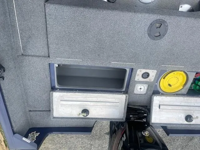 Slide: The Image of 2019 Tracker Pro Guide V-175 Combo boat interior with storage compartments and motor. - 8