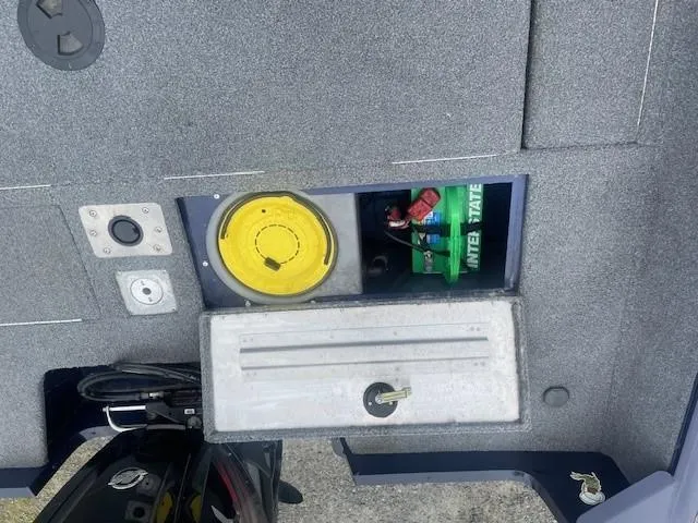 Slide: The Image of 2019 Tracker Pro Guide V-175 Combo boat interior with storage compartments and battery. - 9