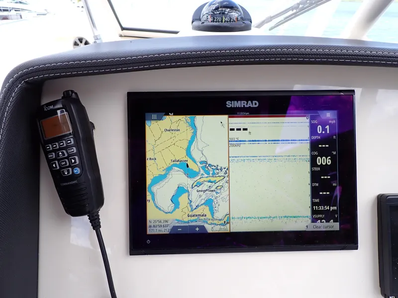 Slide: The Image of Grady-White Freedom 275 2019 boat dashboard with Simrad navigation system. - 19