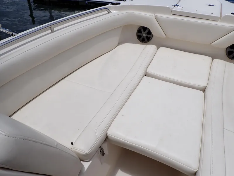 Slide: The Image of 2019 Grady-White Freedom 275 boat with spacious white cushioned seating. - 25