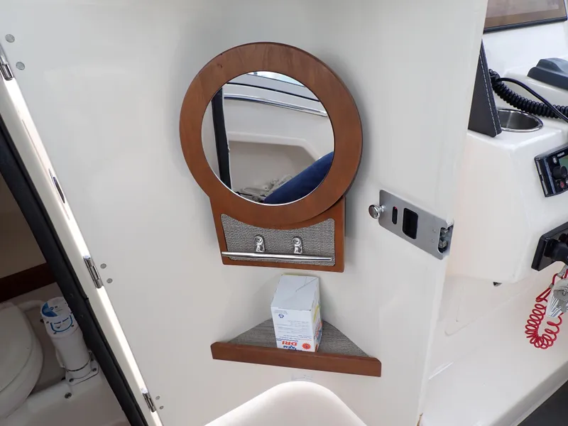 Slide: The Image of 2019 Grady-White Freedom 275 interior with mirror and storage shelf. - 32
