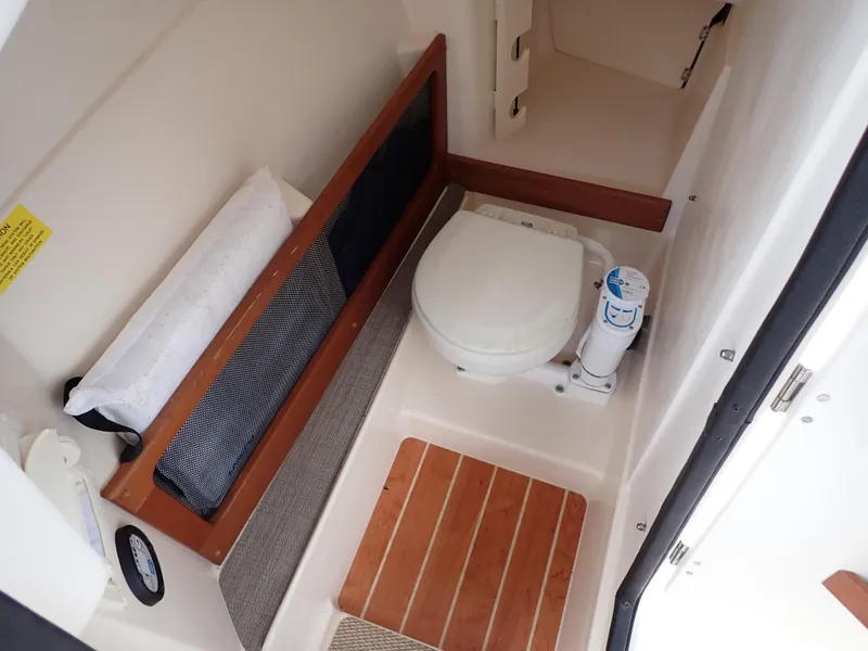 Slide: The Image of 2019 Grady-White Freedom 275 boat interior with toilet and storage compartment. - 33
