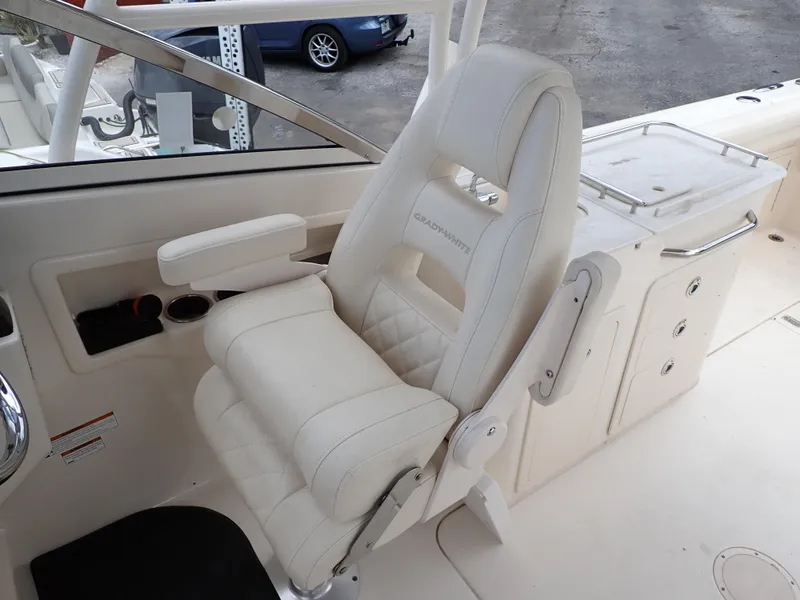 Slide: The Image of 2019 Grady-White Freedom 275 boat interior with white captain's chair and control panel. - 38