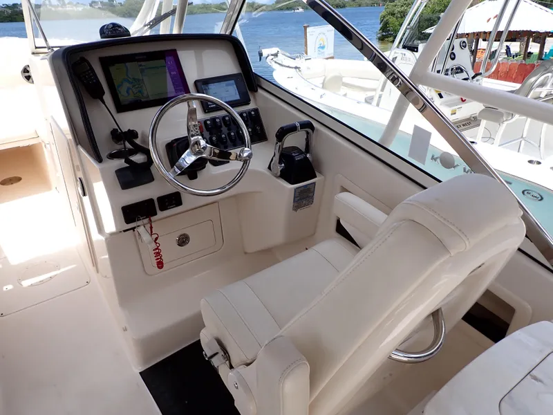 Slide: The Image of 2019 Grady-White Freedom 275 boat helm with steering wheel and navigation system. - 5