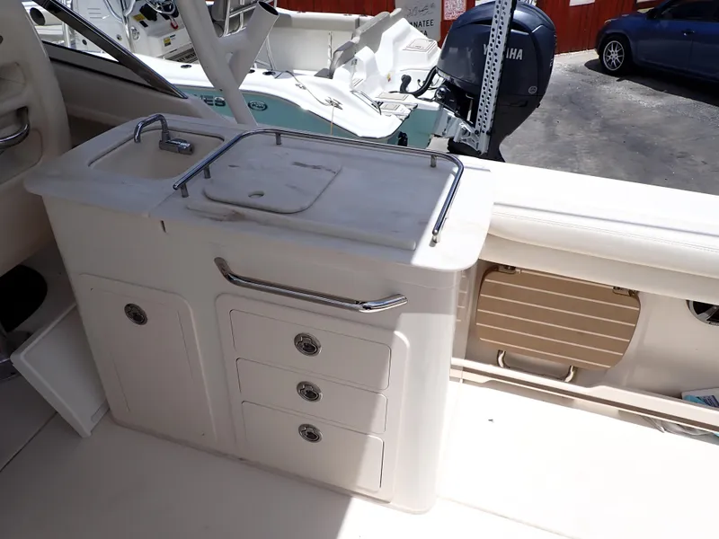 Slide: The Image of 2019 Grady-White Freedom 275 boat interior with sink and storage drawers. - 8