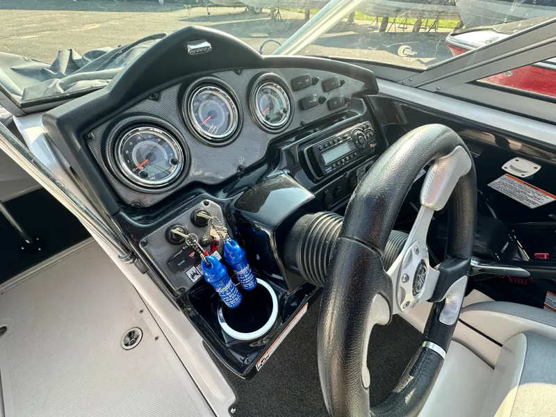 Slide: The Image of Dashboard of a 2012 Yamaha Boats 212X, featuring gauges and steering wheel. - 10