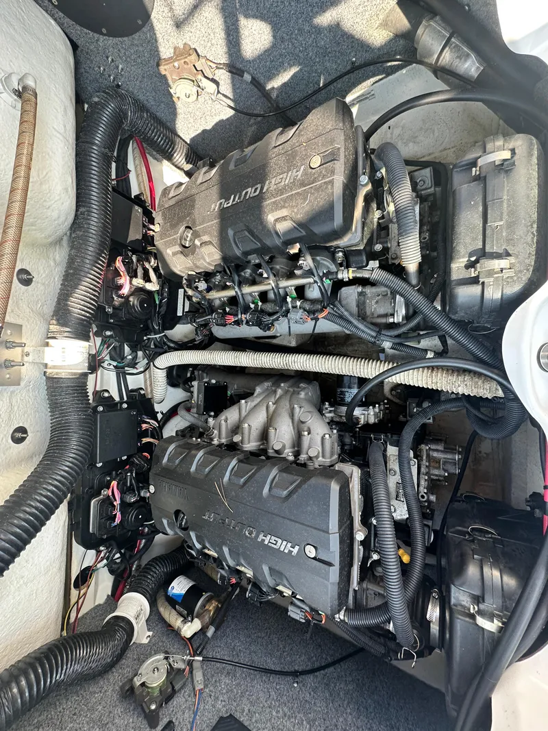 Slide: The Image of 2012 Yamaha Boats 212X engine compartment with dual high-output engines and wiring. - 15