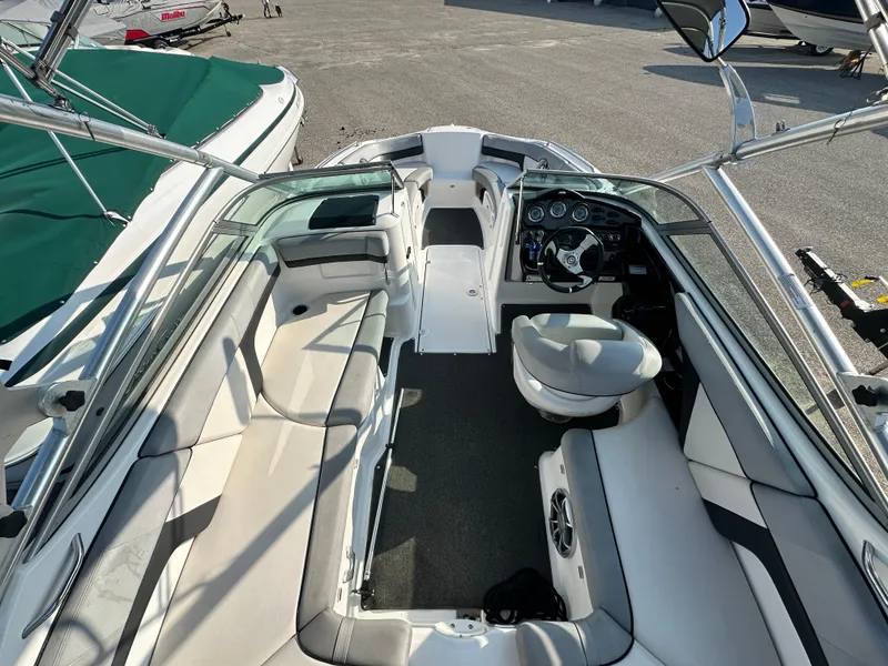 Slide: The Image of Interior view of a 2012 Yamaha Boats 212X, featuring seating and steering console. - 16