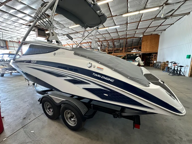 Slide: The Image of 2012 Yamaha Boats 212X in a warehouse, covered and on a trailer. - 2